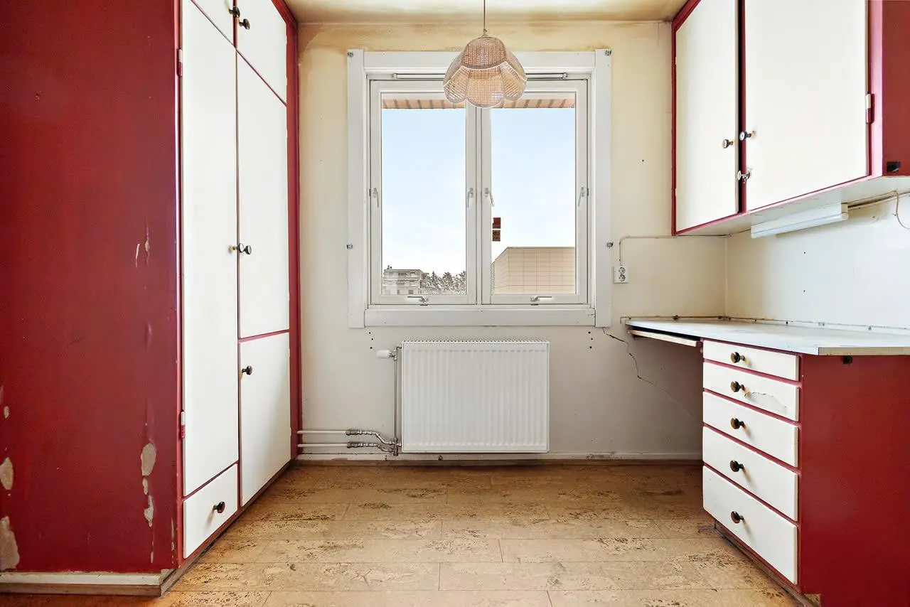 Kjøkken før renovering, med røde fronter og slitte overflater